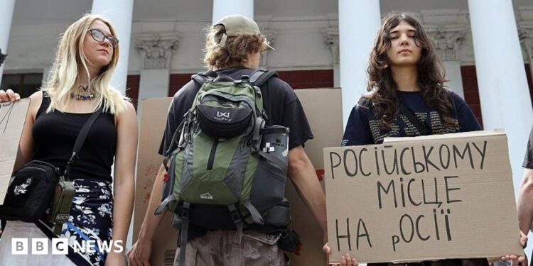 Activists holding placards take part in a rally in support of introducing a moratorium on the public use of Russian-language cultural products on July 8, 2026 in Odesa, Ukraine