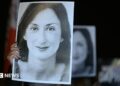 Protesters hold a black and white picture of the late journalist Daphne Caruana Galizia
