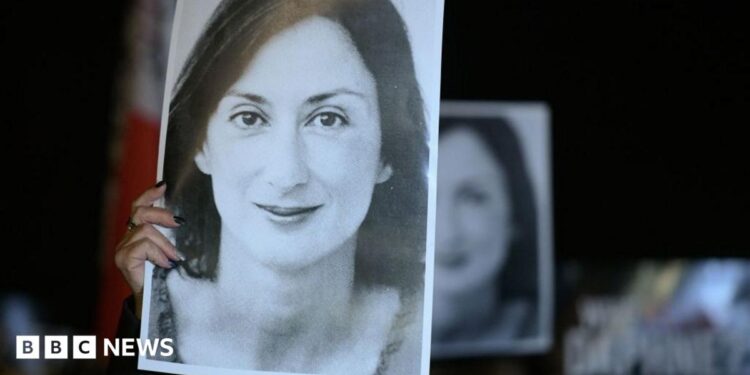 Protesters hold a black and white picture of the late journalist Daphne Caruana Galizia