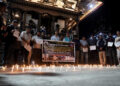 People observe a moment of silence as they gather at the Basantapur Durbar Square to mark a national mourning day in Kathm...