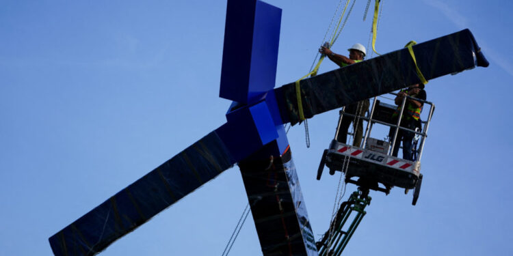 Crews work to remove the sculpture titled "Blue" by artist Joel Shapiro from the grounds of the Kennedy Center for the Per...