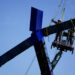 Crews work to remove the sculpture titled "Blue" by artist Joel Shapiro from the grounds of the Kennedy Center for the Per...