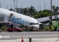 Crews investigate the site of an Amazon cargo plane crash at Miami International Airport on 8 September
