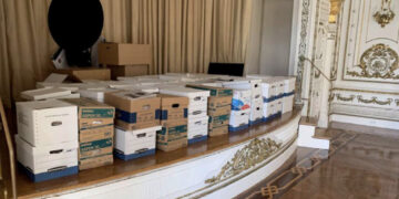 Photographs of former U.S President Donald Trump boxes of classified documents stored on a ballroom stage, in a club bathroom