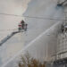 Firefighters work at a site of a building of the headquarters of Ukraine's SBU security service after a Russian drone stri...
