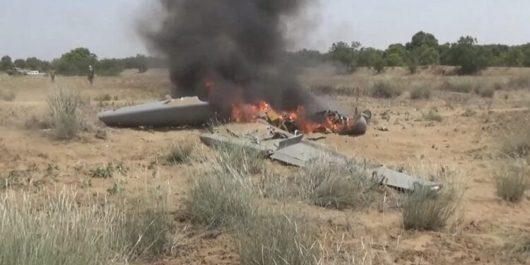 Flames rise from a downed drone, in a location given as Hajjah