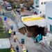 Debris and warped road pictured in front of sinkhole beside white house in Malibu