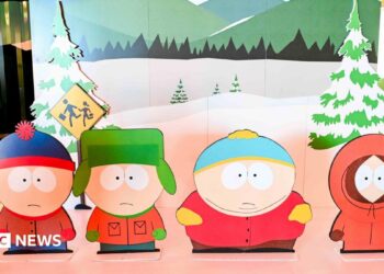 Characters from South Park TV show as cut-outs on a stage with a wintery backdrop.