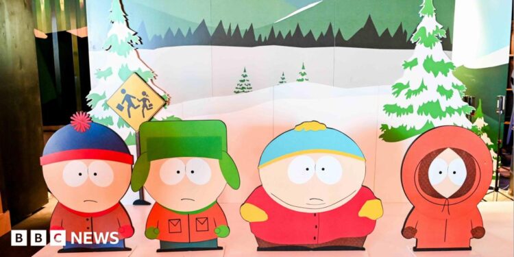 Characters from South Park TV show as cut-outs on a stage with a wintery backdrop.