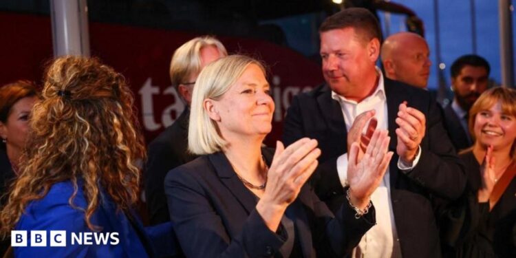 Sweden's Social Democratic Party leader, Magdalena Andersson applauds as she waits with other party members for general election results