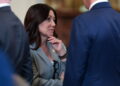 U.S. Labor Secretary Chavez-DeRemer speaks with fellow cabinet members before an event at the White House in Washington