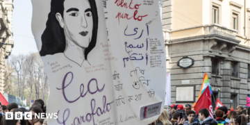 A woman holds a placard with the portrait of an Italian justice collaborator and victim of the 'Ndrangheta Lea Garofalo during a protest in Milan on 21 March 2023 in Milan, Italy.