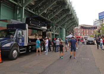 fans observe the section of the south tower on display at Fenway Park