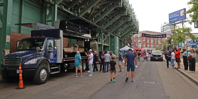 fans observe the section of the south tower on display at Fenway Park