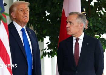 US President Donald Trump speaks to Canadian Prime Minister Mark Carney  during a welcome outside the West Wing of the White House in October 2025