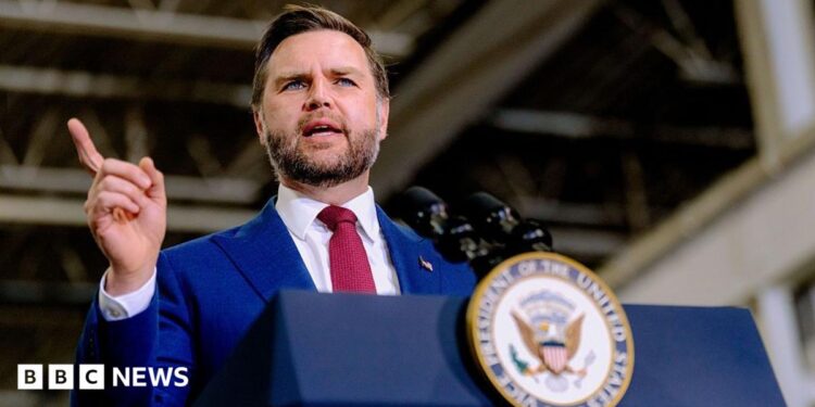 US Vice-President JD Vance speaks behind a lectern
