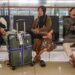 Stranded passengers rest on a bench at Soekarno-Hatta Airport in Tangerang on September 6, 2026